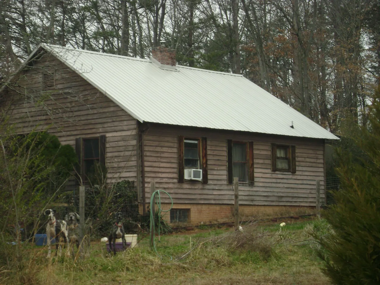 White metal roof on an old wood sided farmhouse, from a Metal Roof Installation job in Dobbs Ferry